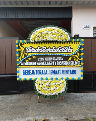Papan Bunga Duka di Motto